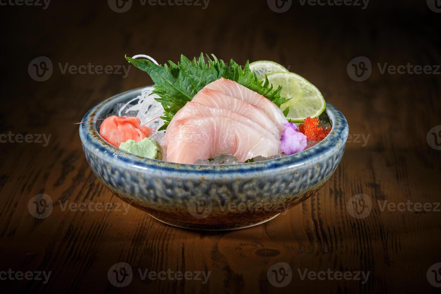 Bowl with delicious sashimi on wooden table photo