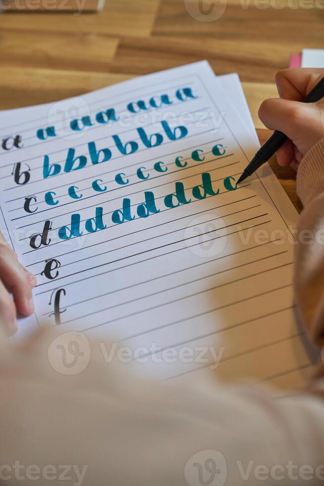 Crop unrecognizable person drawing letters photo