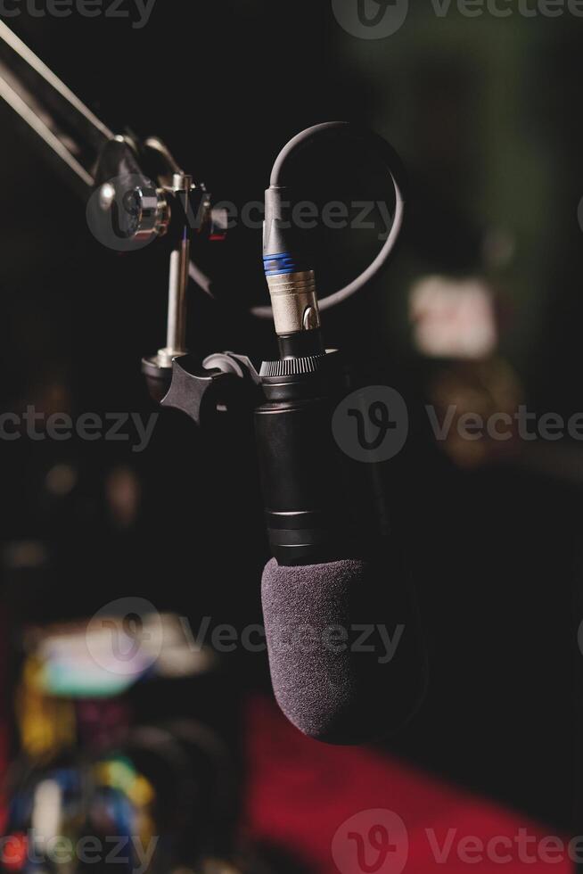 Modern microphone in dark studio photo