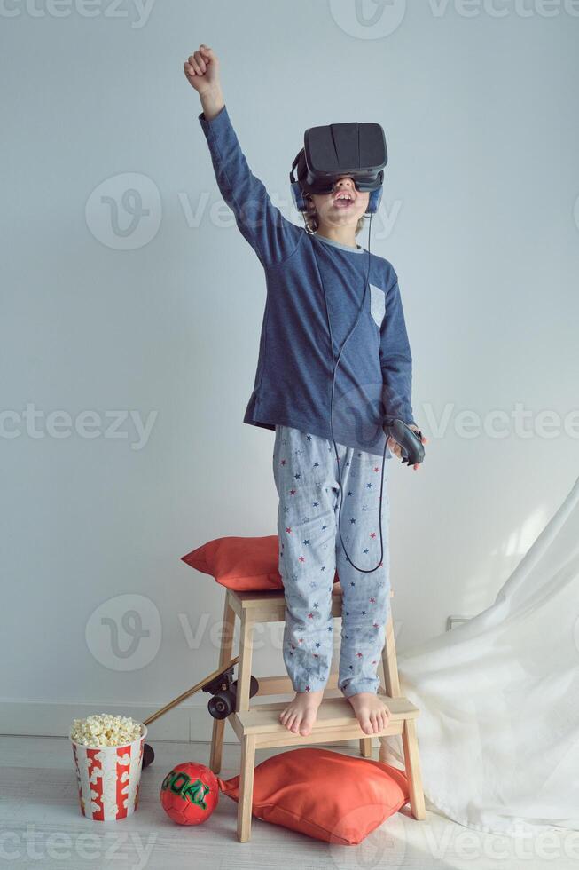 Boy playing VR game with gamepad photo