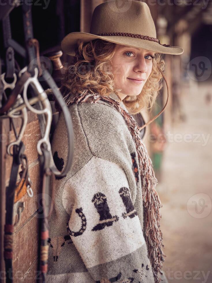 Stylish fair haired female in cowboy wear photo