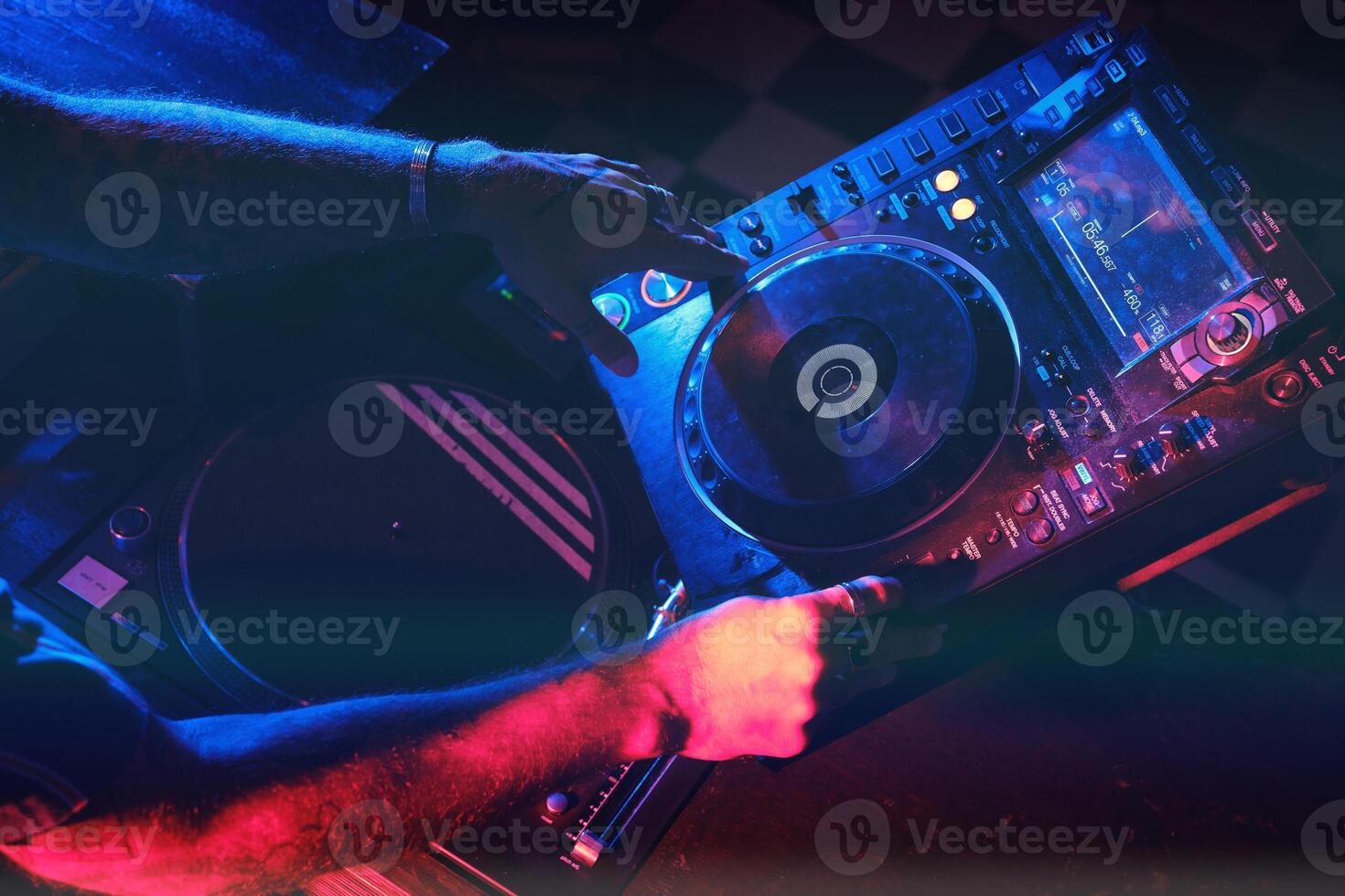 Anonymous DJ playing song on CDJ player photo