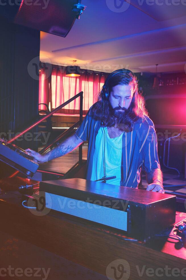 Man playing music at DJ setup photo
