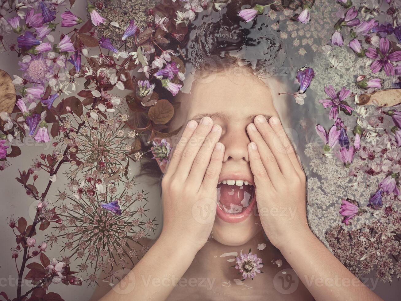 Boy screaming in bath with flowers photo