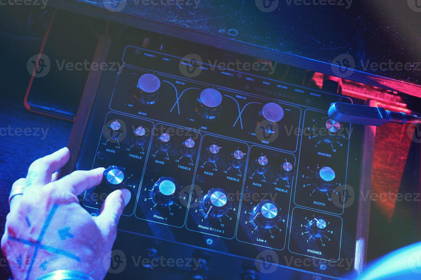Unrecognizable man playing on DJ mixer photo
