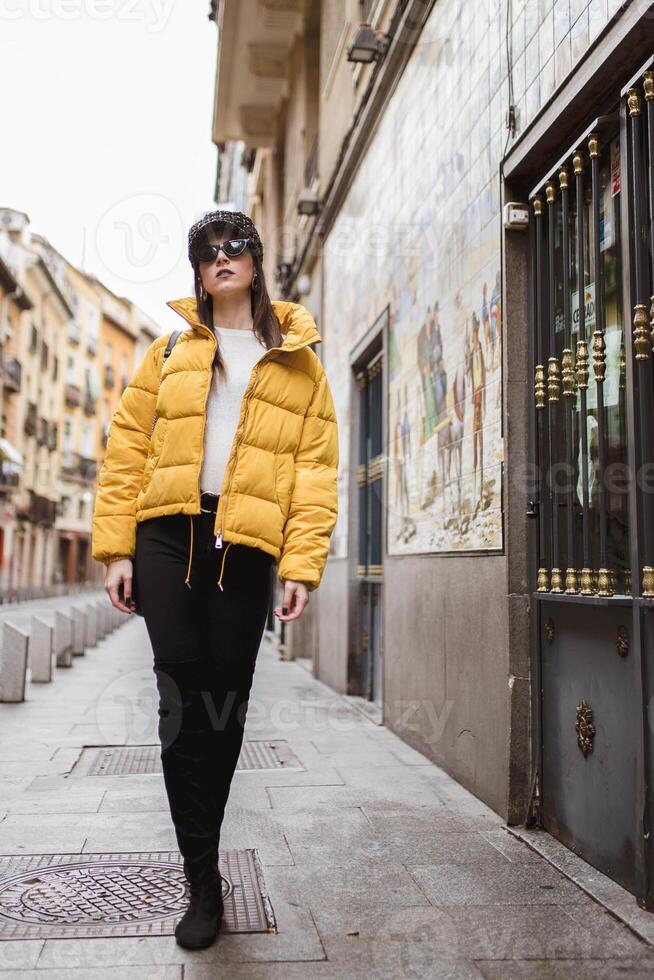 Trendy lady walking on street photo
