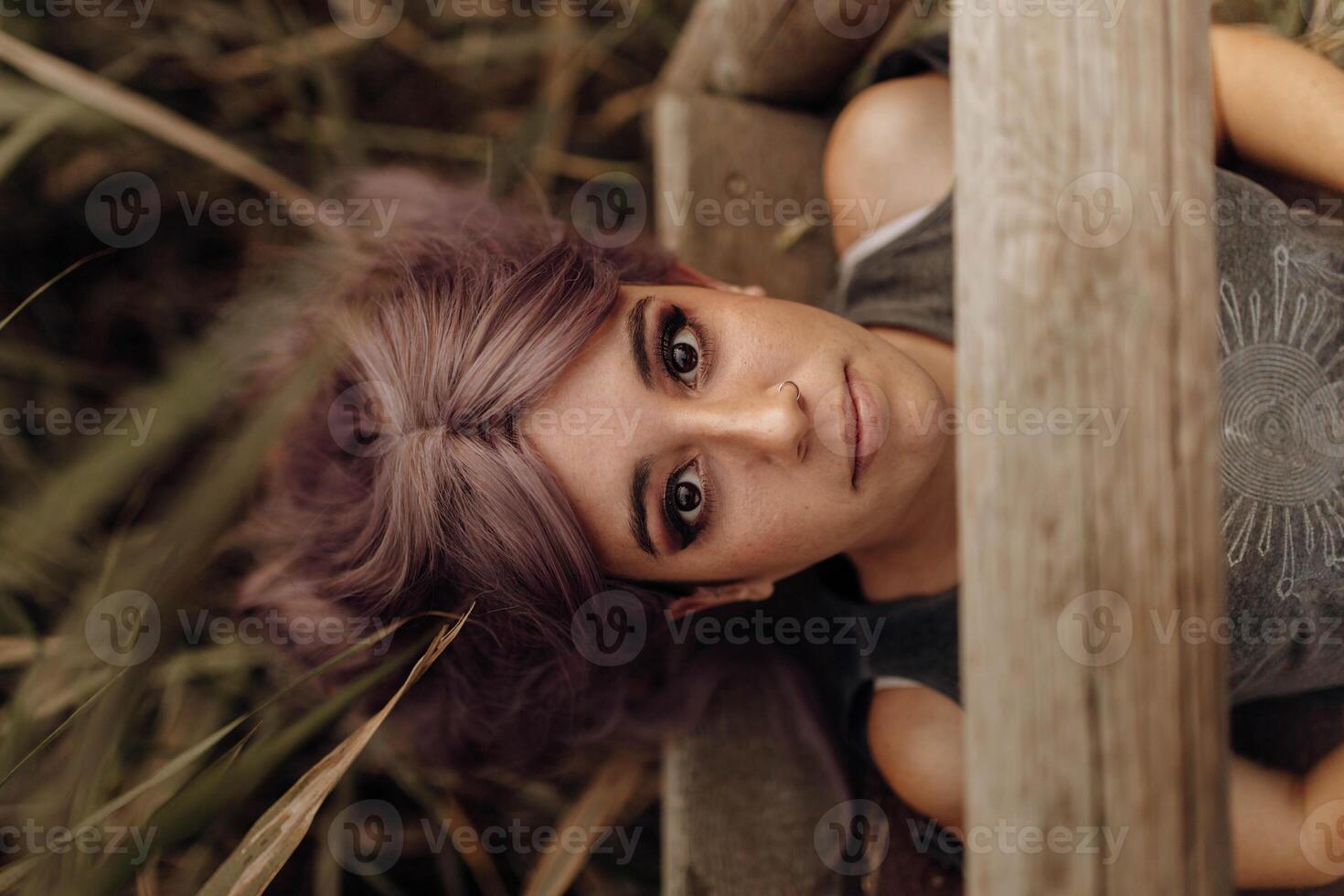 Beautiful woman lying on wood pier photo