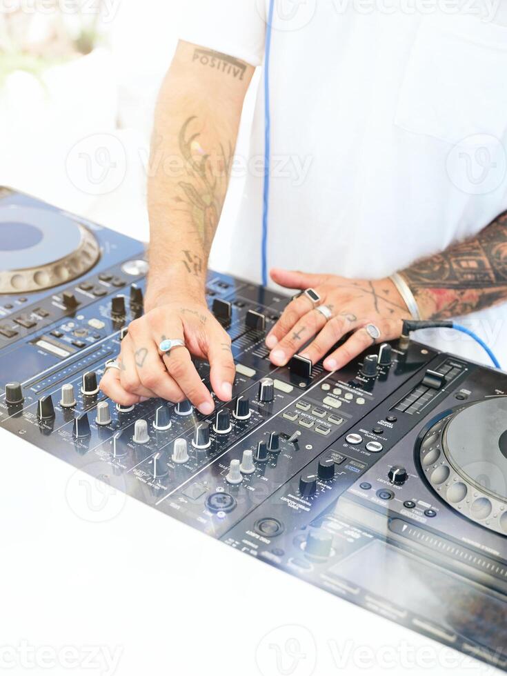 Crop DJ playing music on console photo