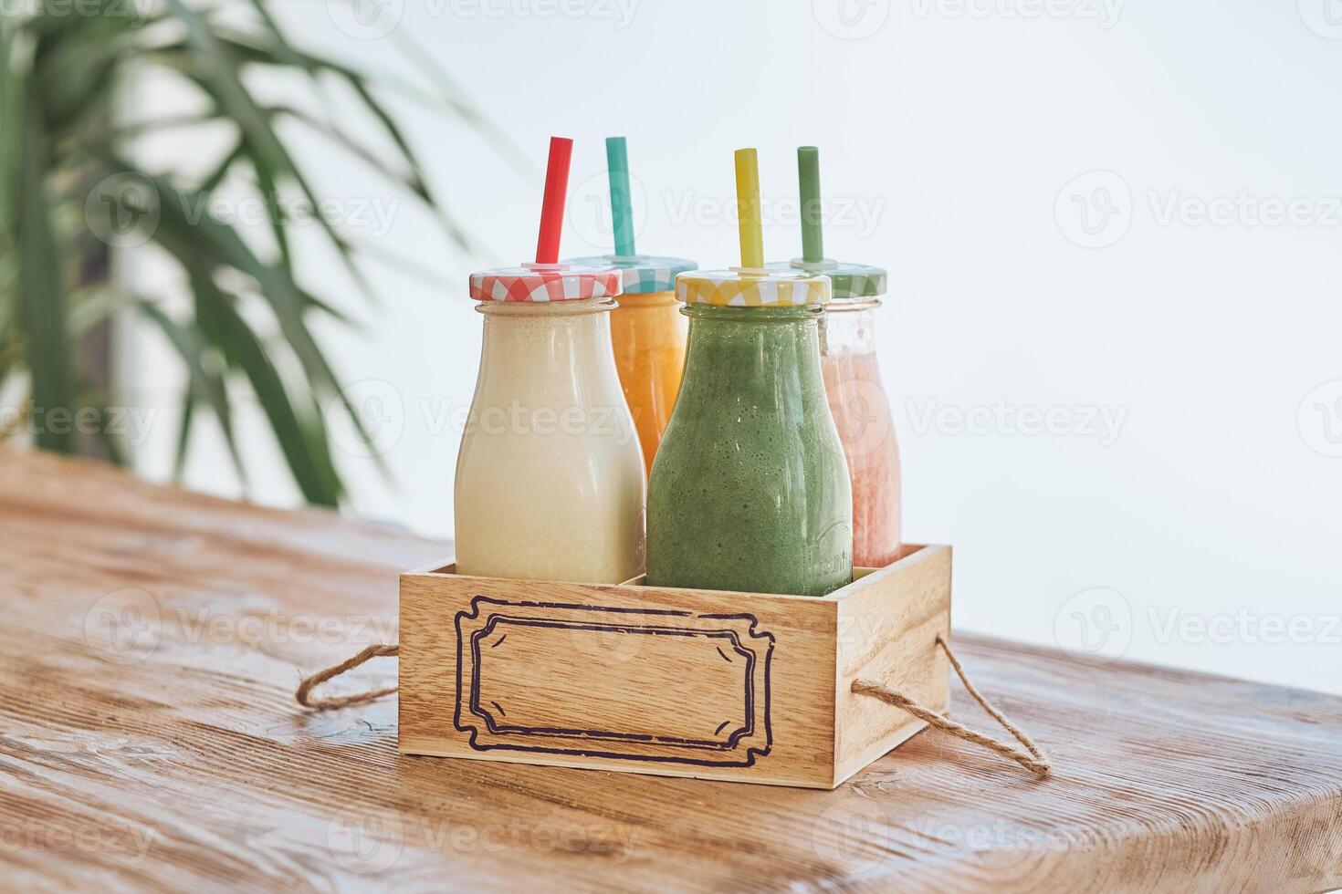 Smoothies bottles in wooden box photo