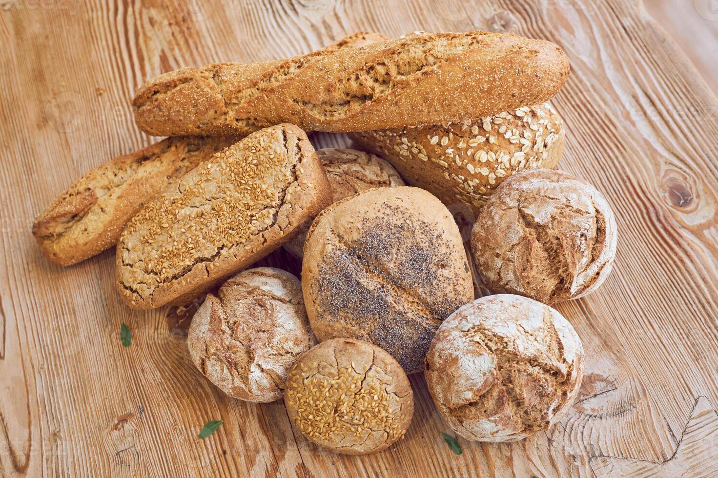 Pile of bread on wooden table photo