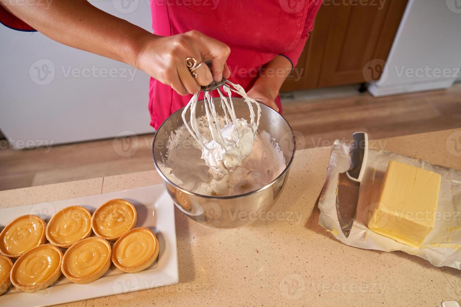 Faceless woman mixing cream in bowl photo