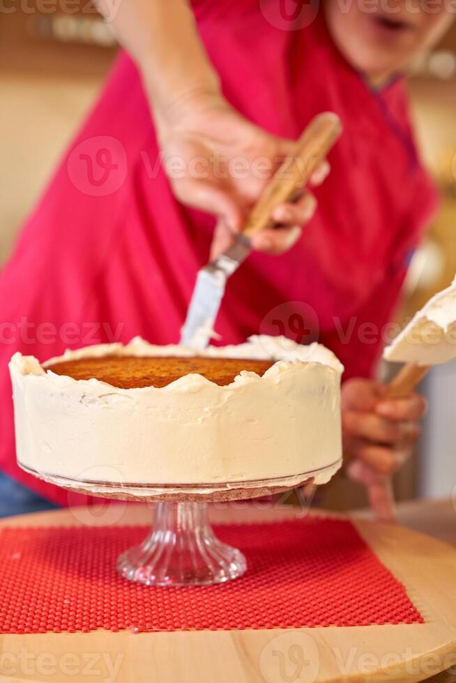 Crop woman making cake in kitchen photo