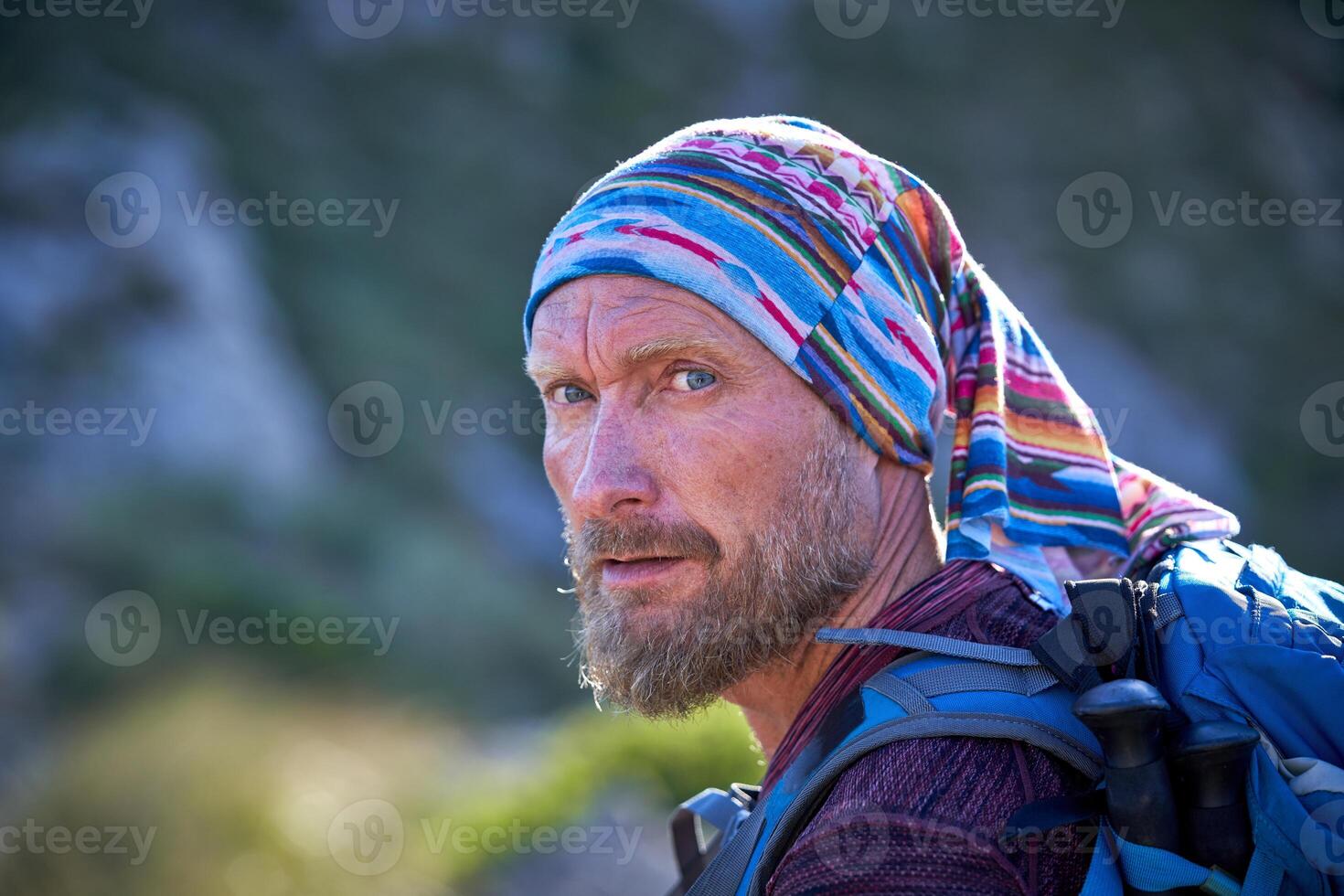 Mature traveling man looking away in nature photo
