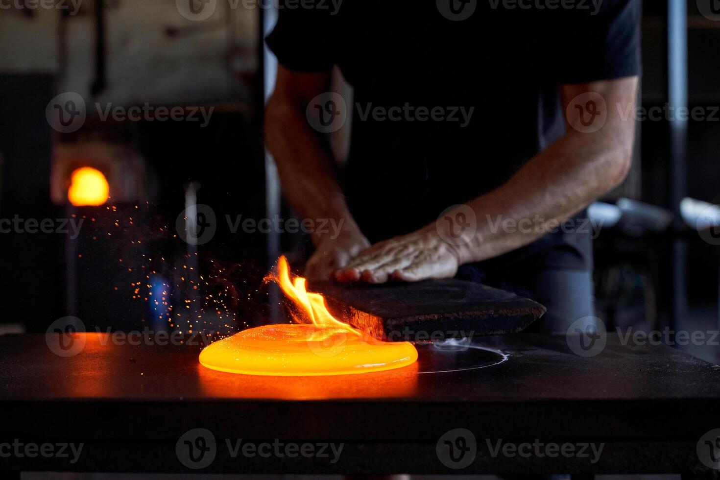 Crop craftsman working at glassblowing factory photo