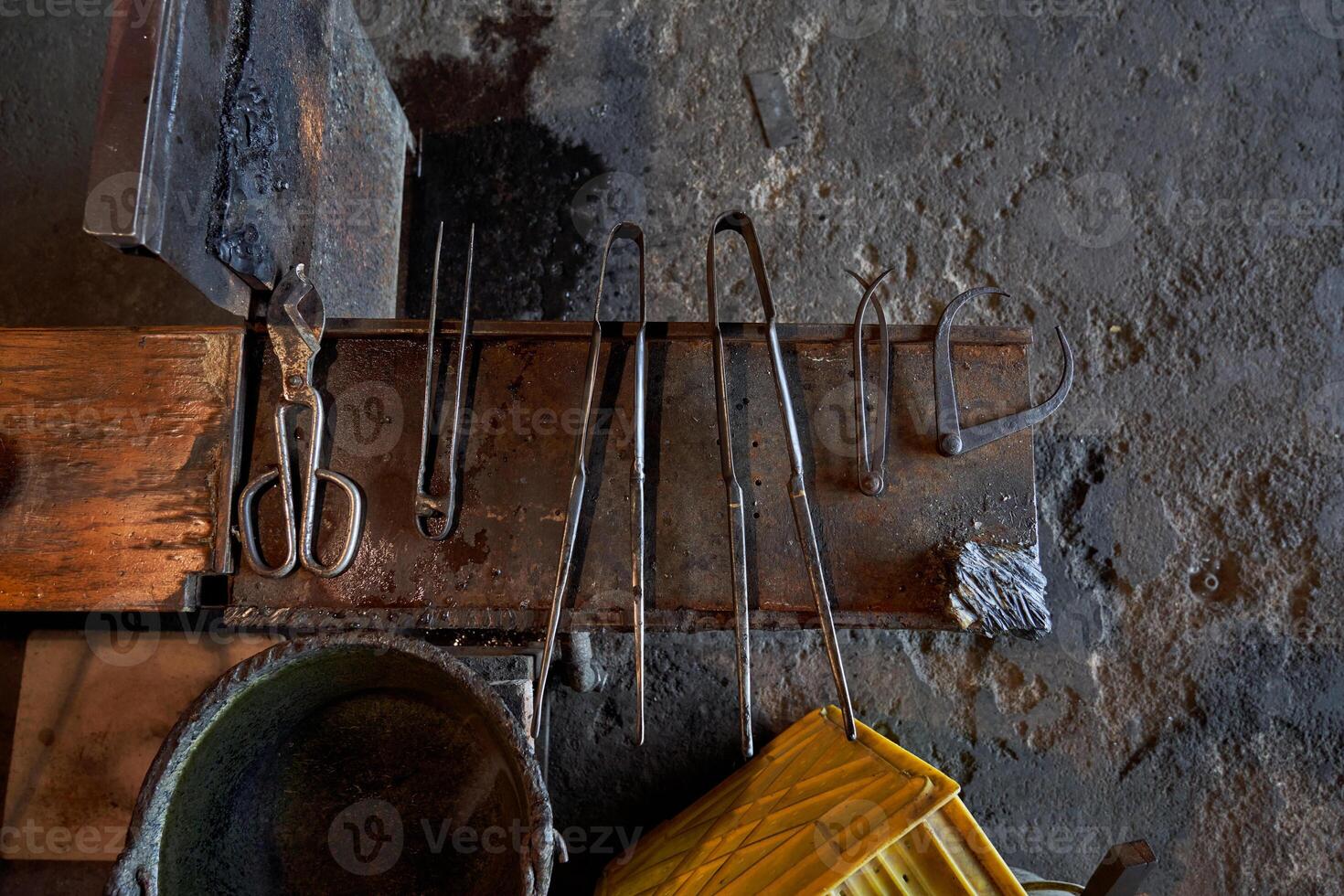 Metal tools on workbench in glass making factory photo