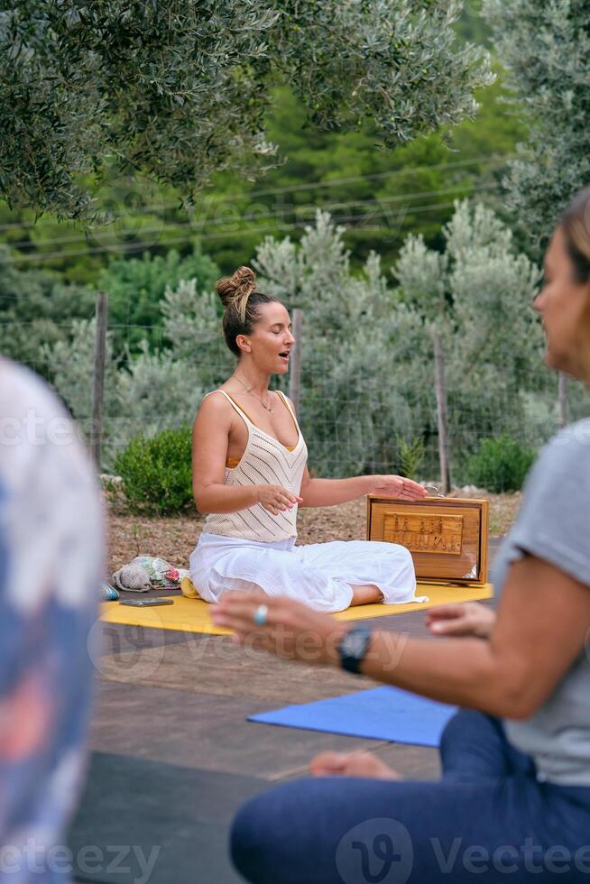 Woman with opened mouth practicing yoga with people photo