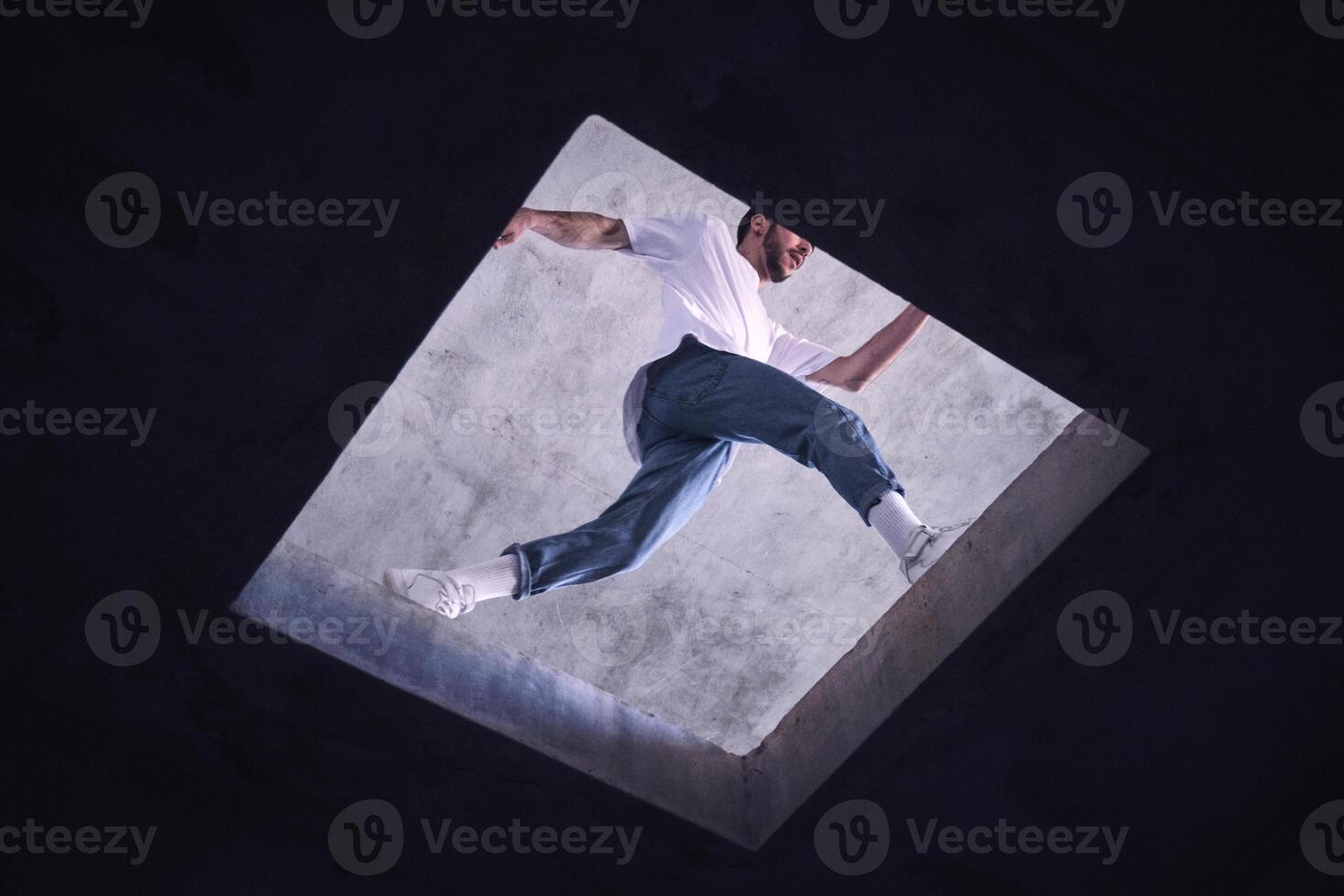 Unrecognizable man jumping near floor opening photo