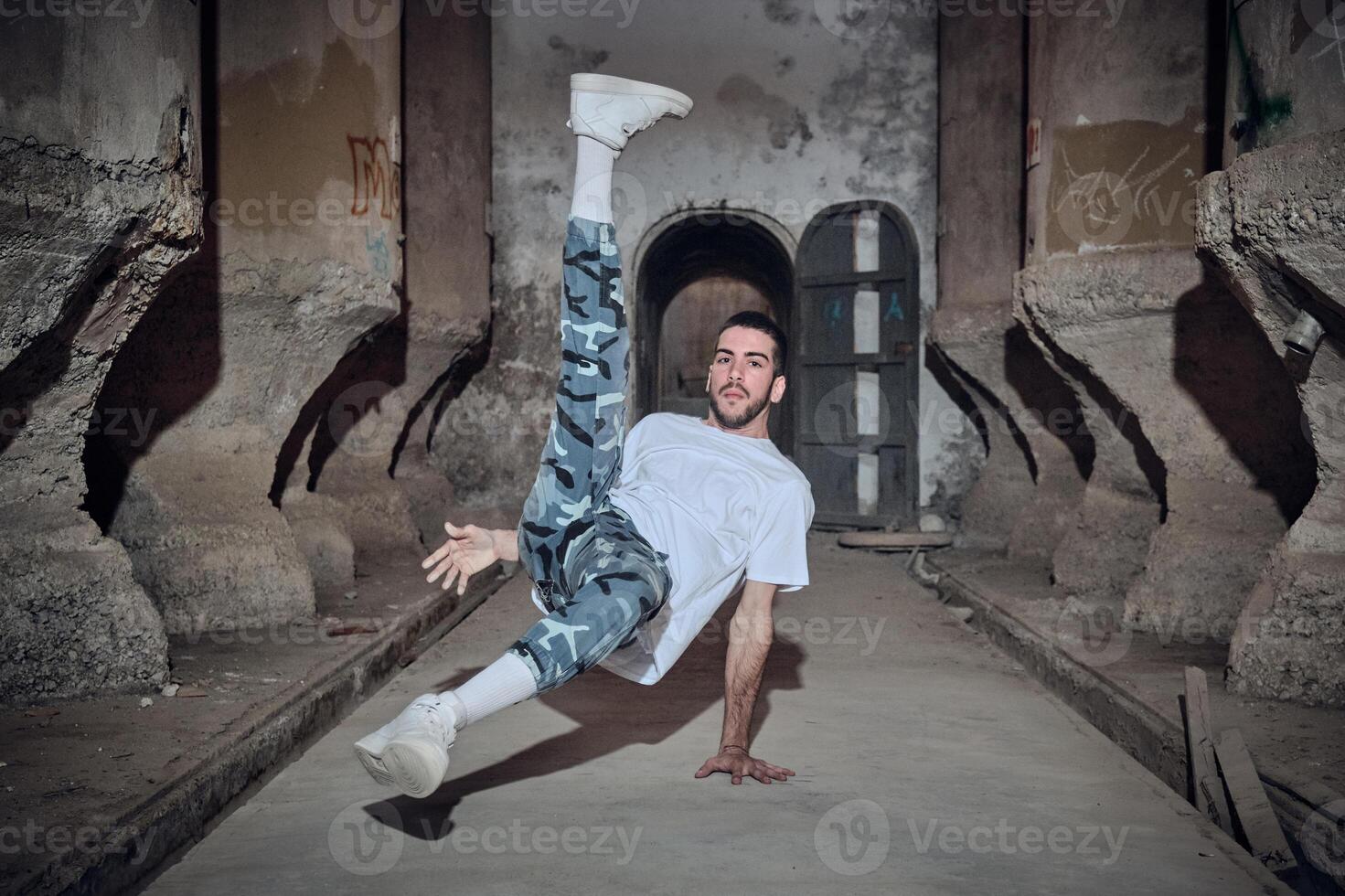 Active man break dancing in abandoned building photo