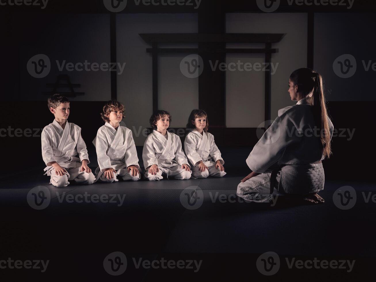 Krav Maga trainer with group of kids in studio photo