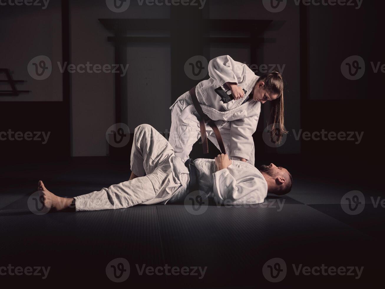Krav Maga trainer teaching man to defend from gun photo