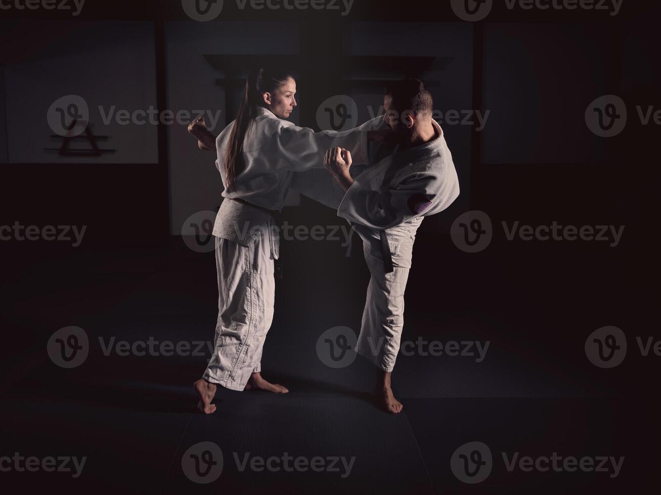 Man kicking woman during Krav Maga training photo