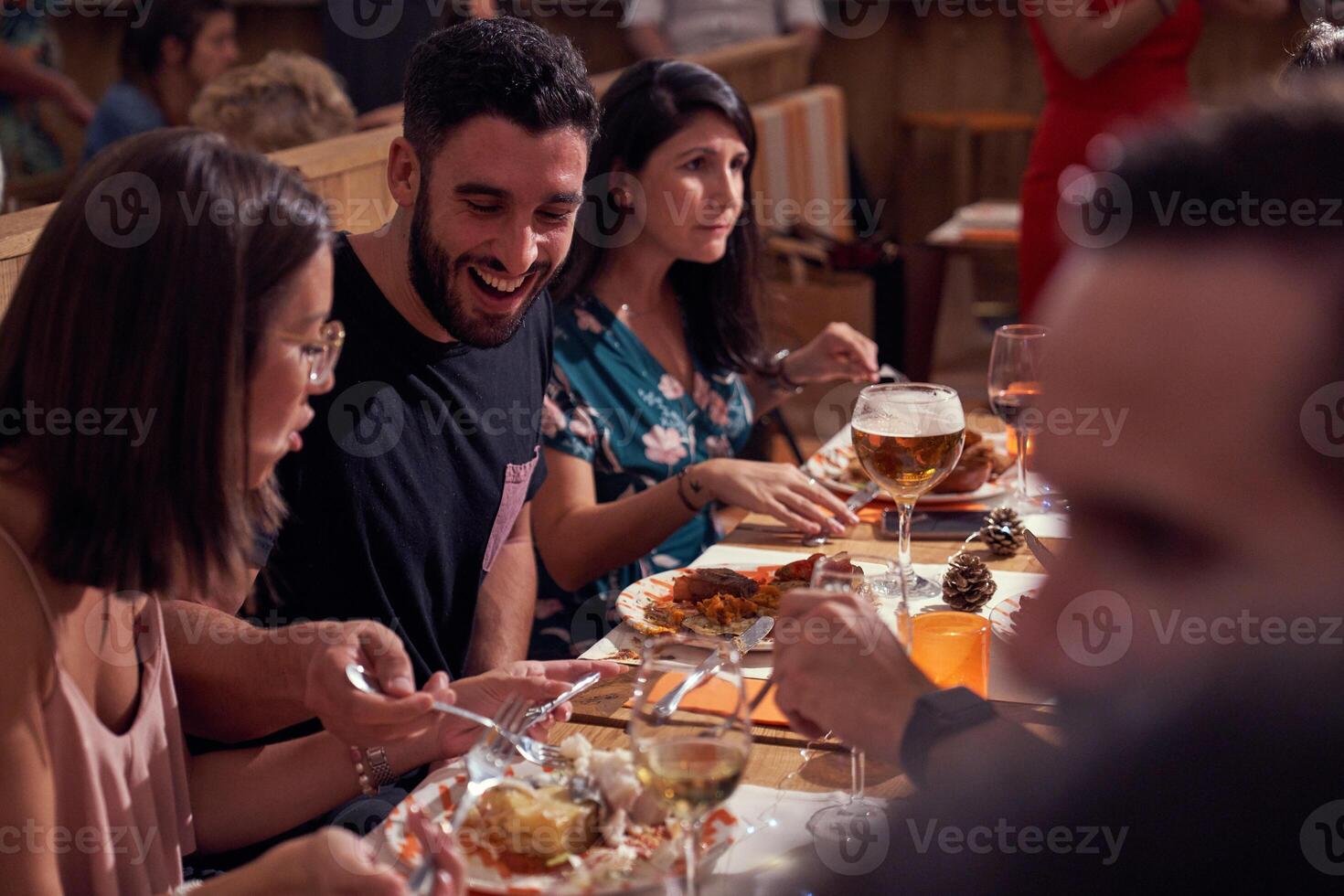 Cheerful friends eating in restaurant photo