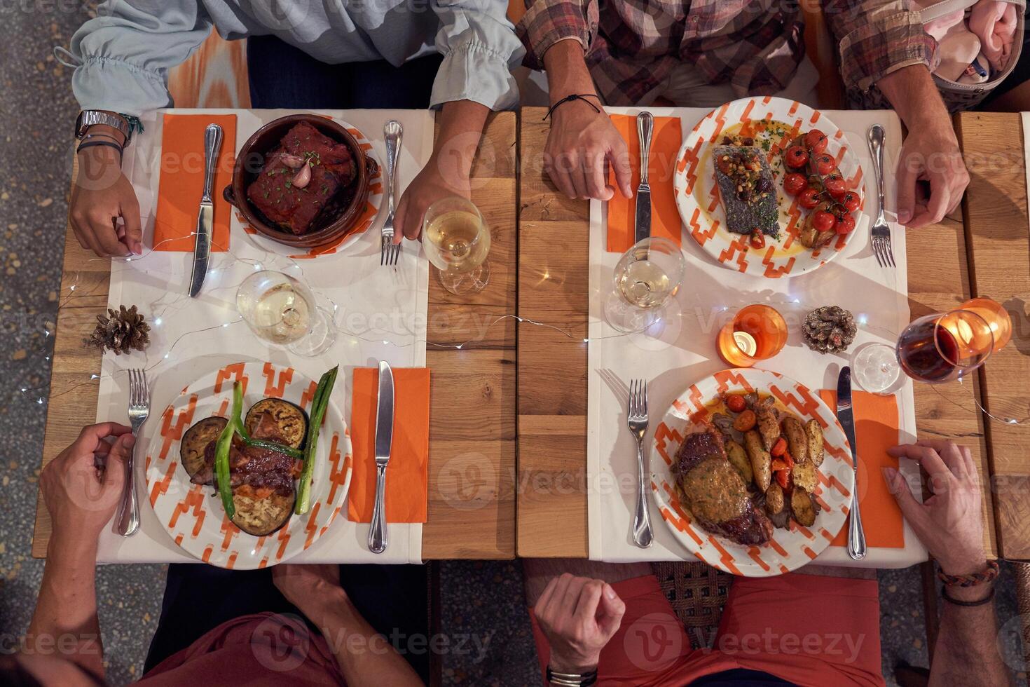 Unrecognizable friends having dinner in restaurant photo