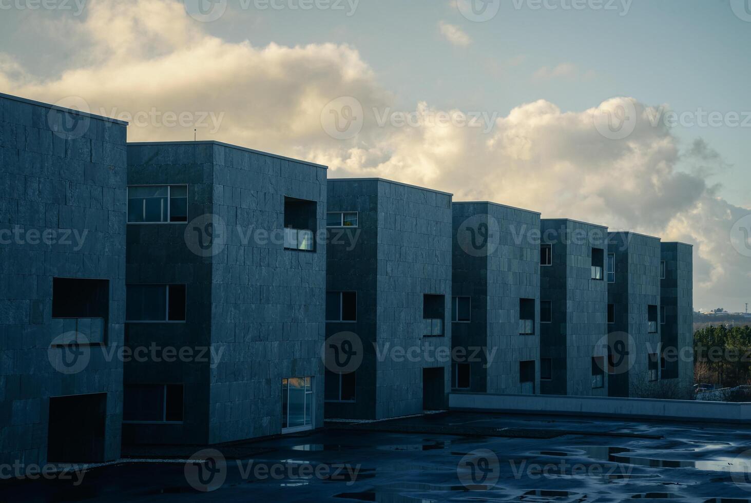 A row of grey buildings soaked by rain photo
