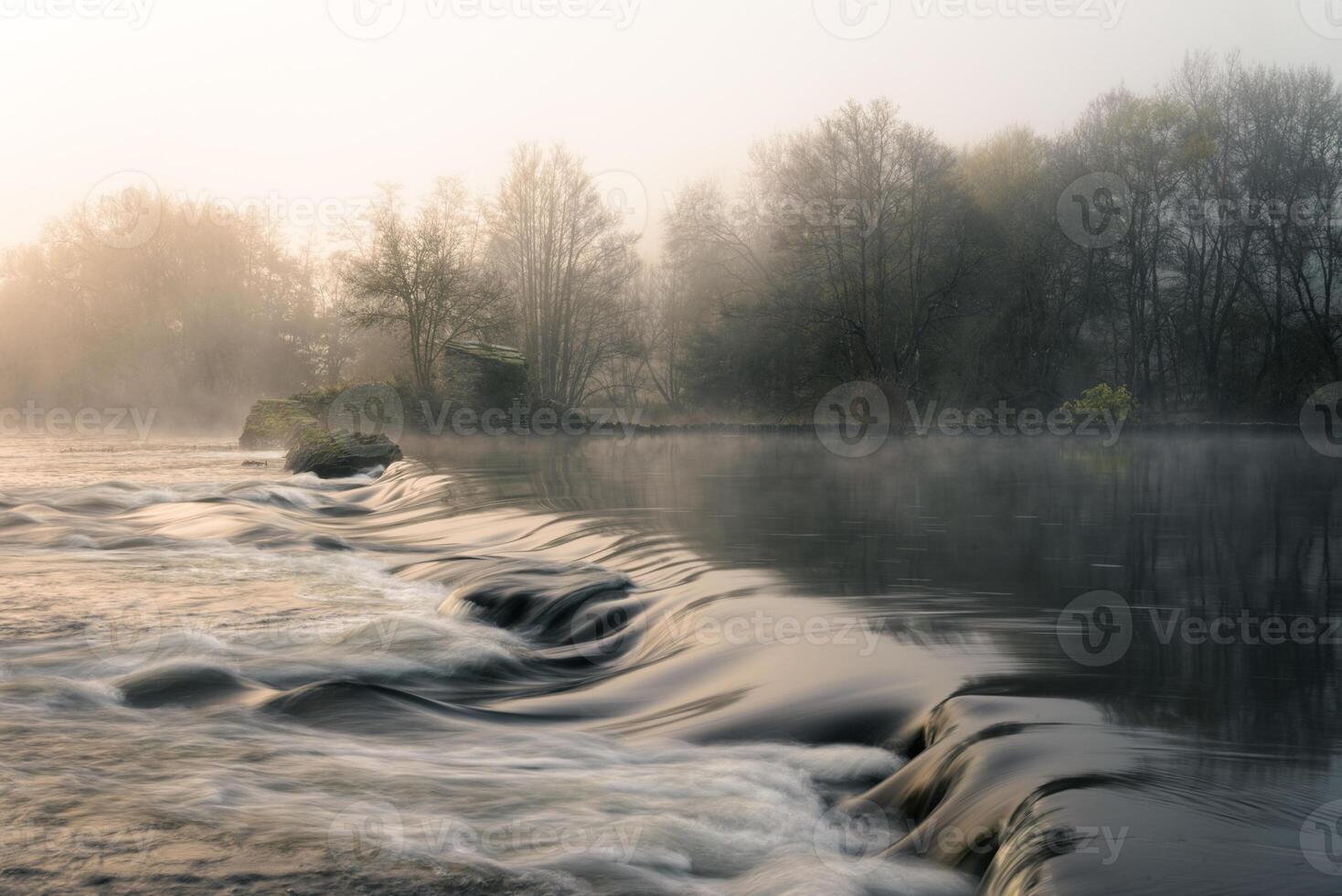 The Mino River under a light morning mist in spring photo