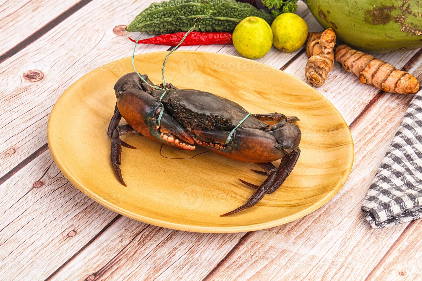 A crab on a plate with other food photo