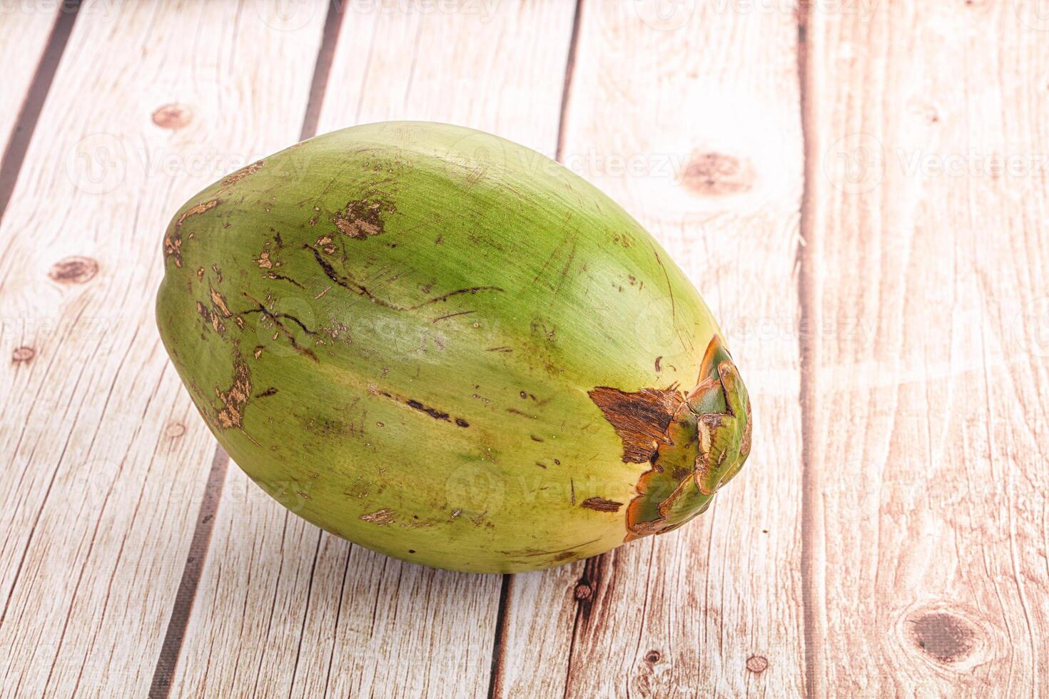 A coconut on a wooden table photo