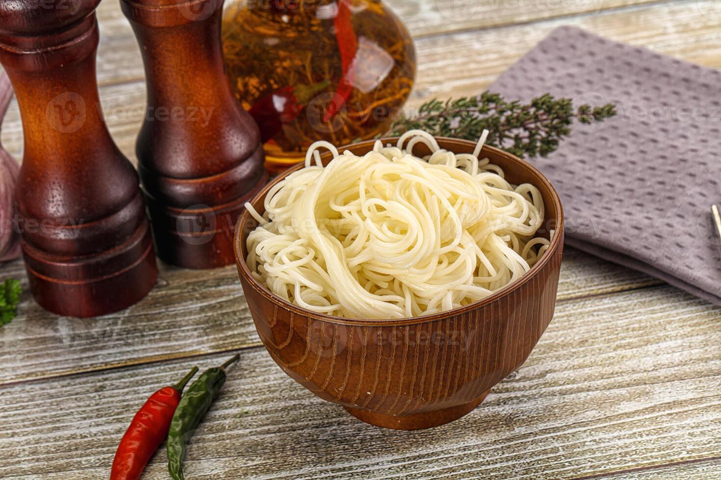 A bowl of noodles on a wooden table photo