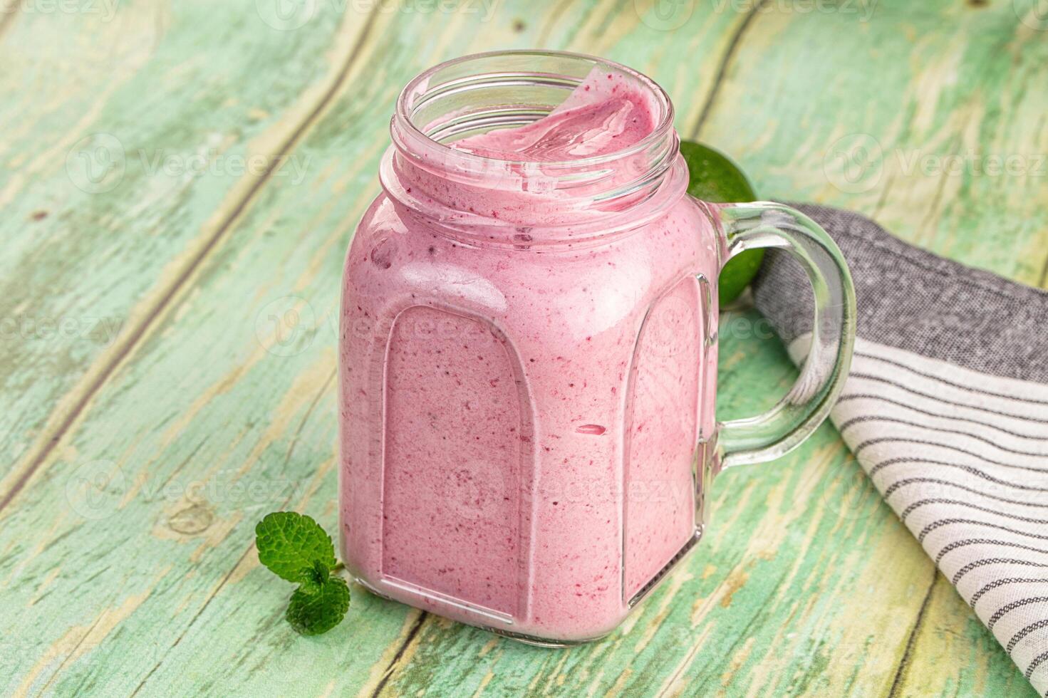 A glass jar with a smoothie in it photo
