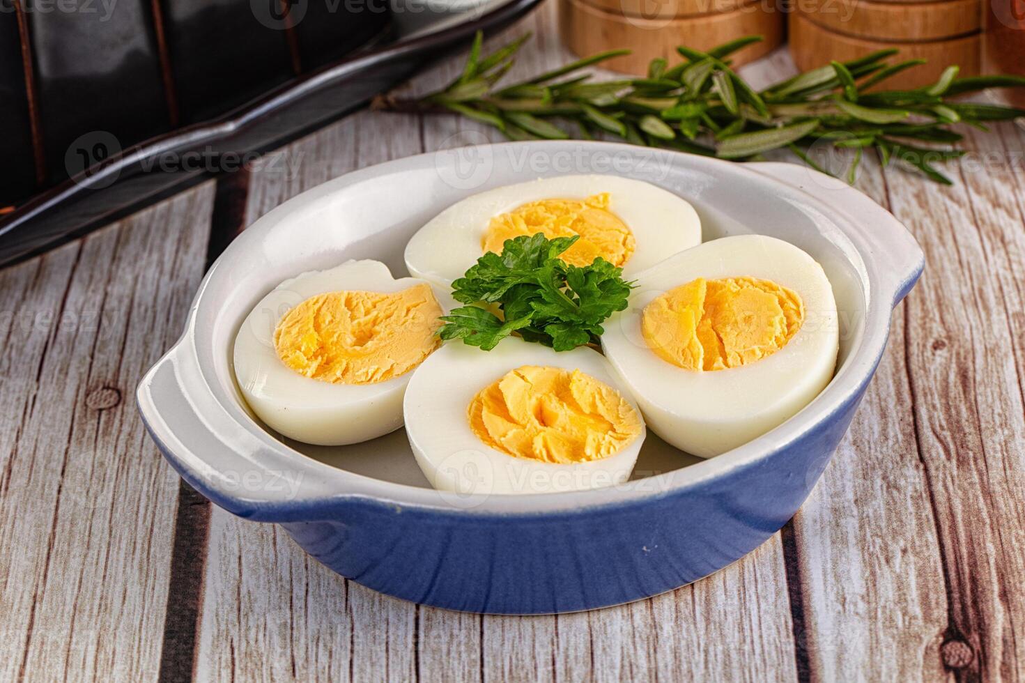 Hard boiled eggs in a bowl on a wooden table photo