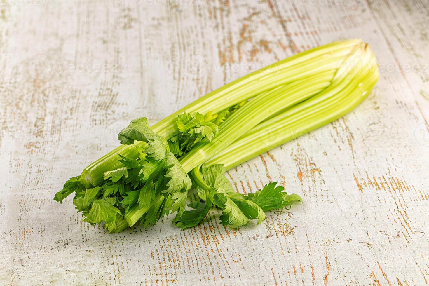 A celery stalk on a white table photo