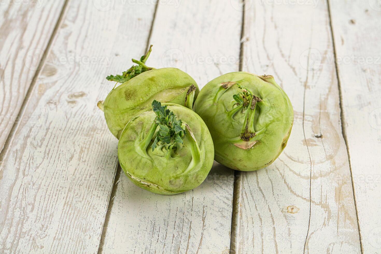 Three green vegetables on a white table photo