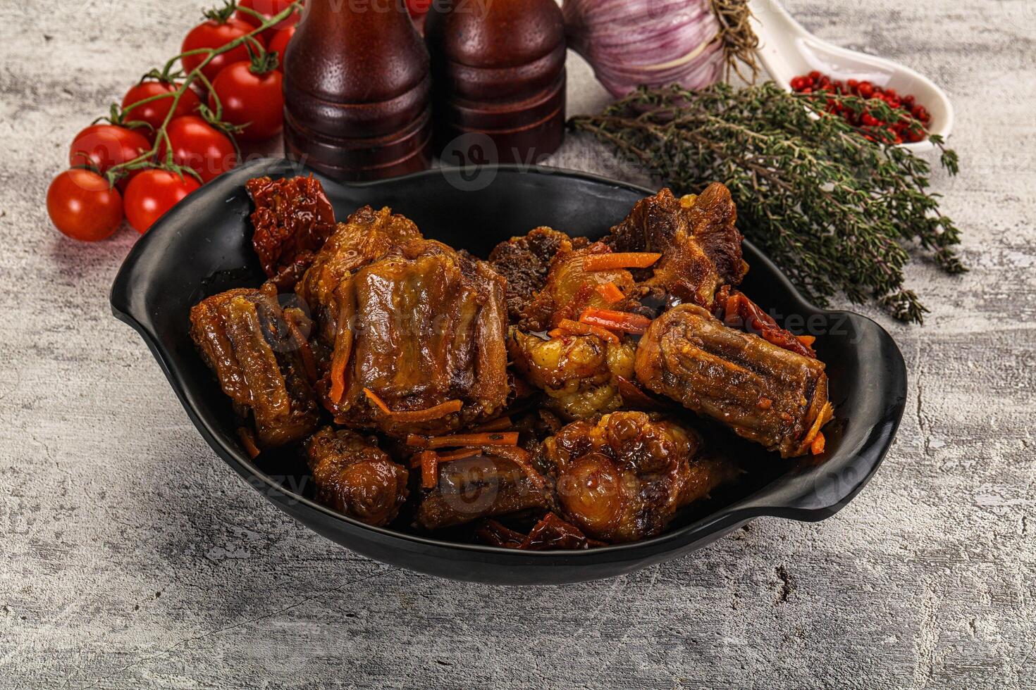 A bowl of meat and vegetables on a table photo