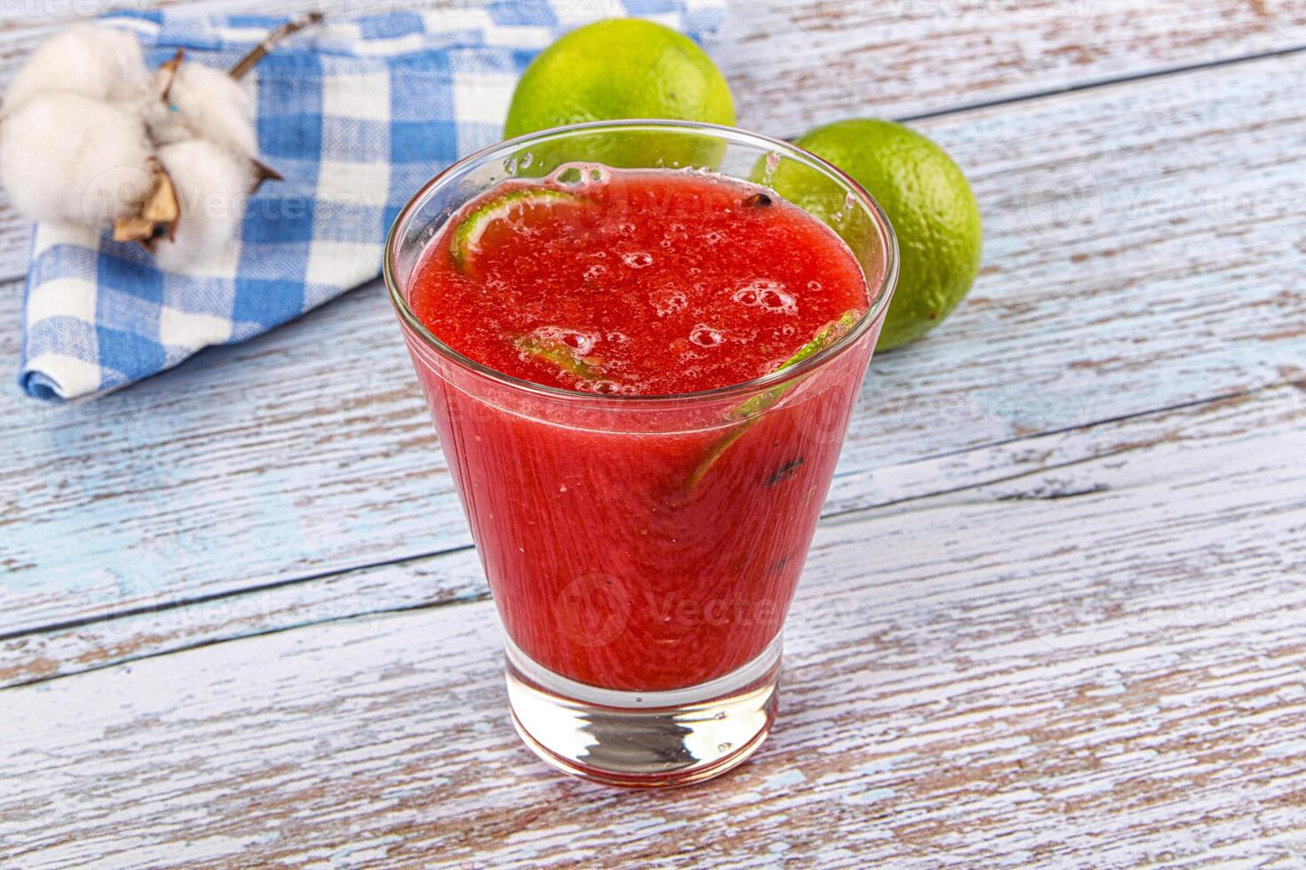 A glass of watermelon juice on a wooden table photo