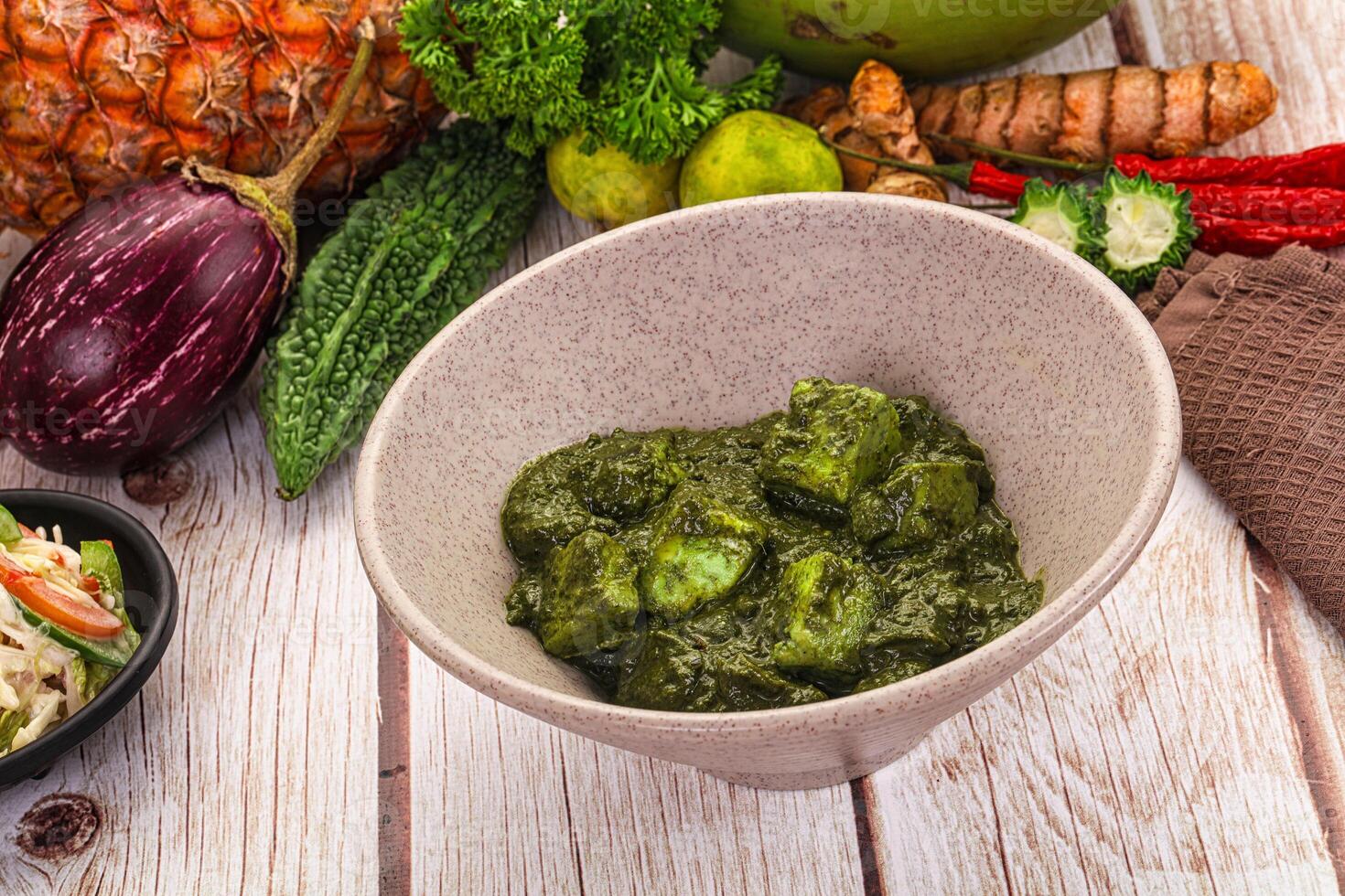 A bowl of food on a table with other food photo