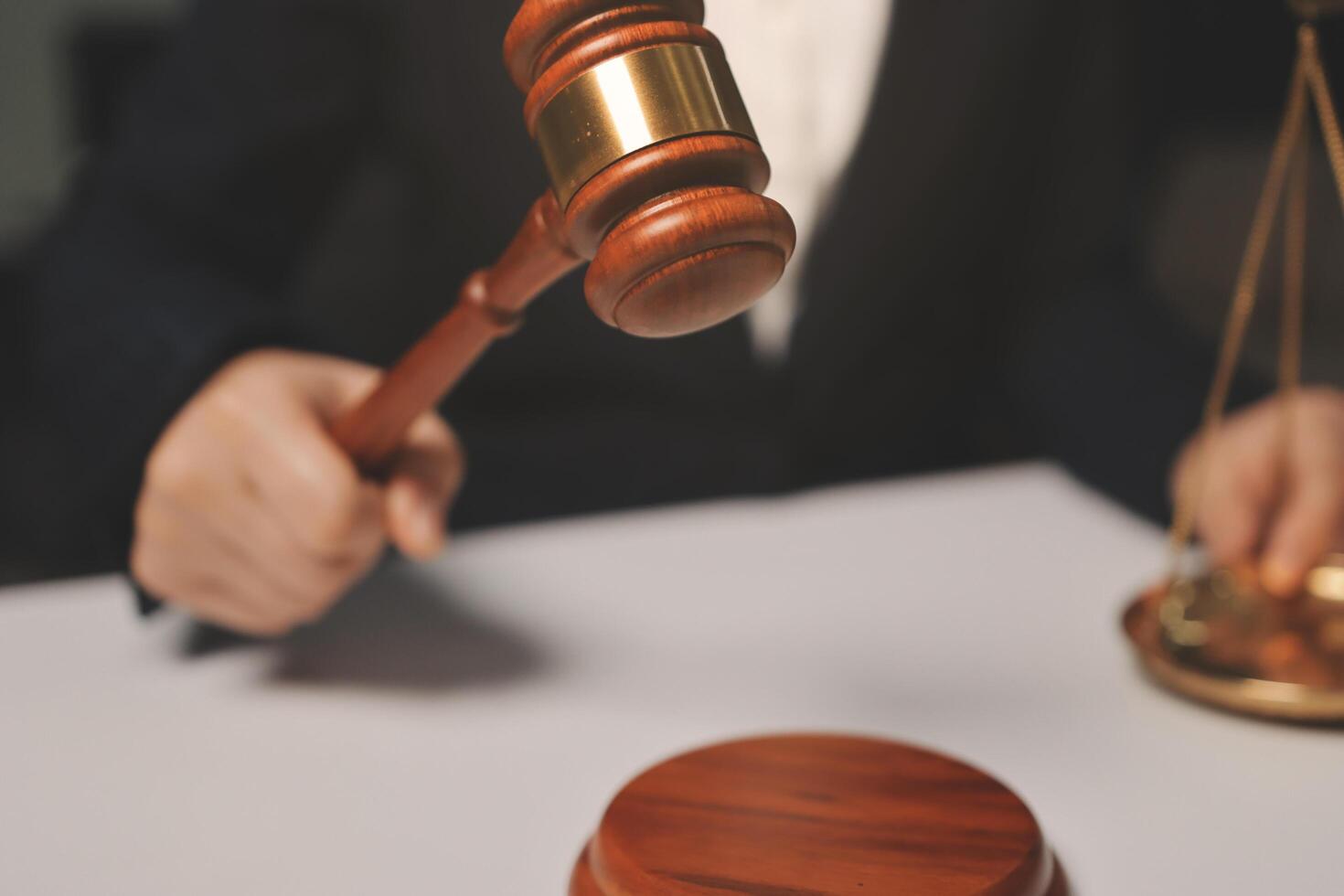 A judge's gavel is in the hand of a businesswoman photo