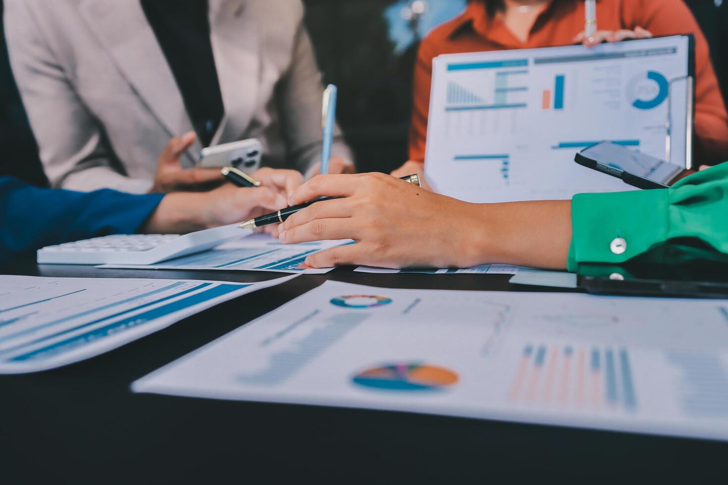 Business people working on papers with graphs and charts photo