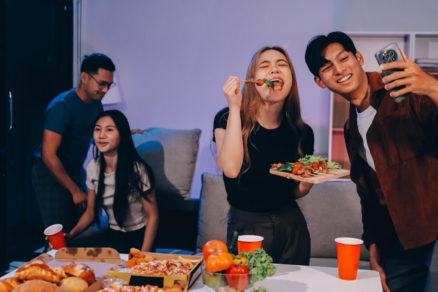 A group of people enjoying pizza and drinks photo