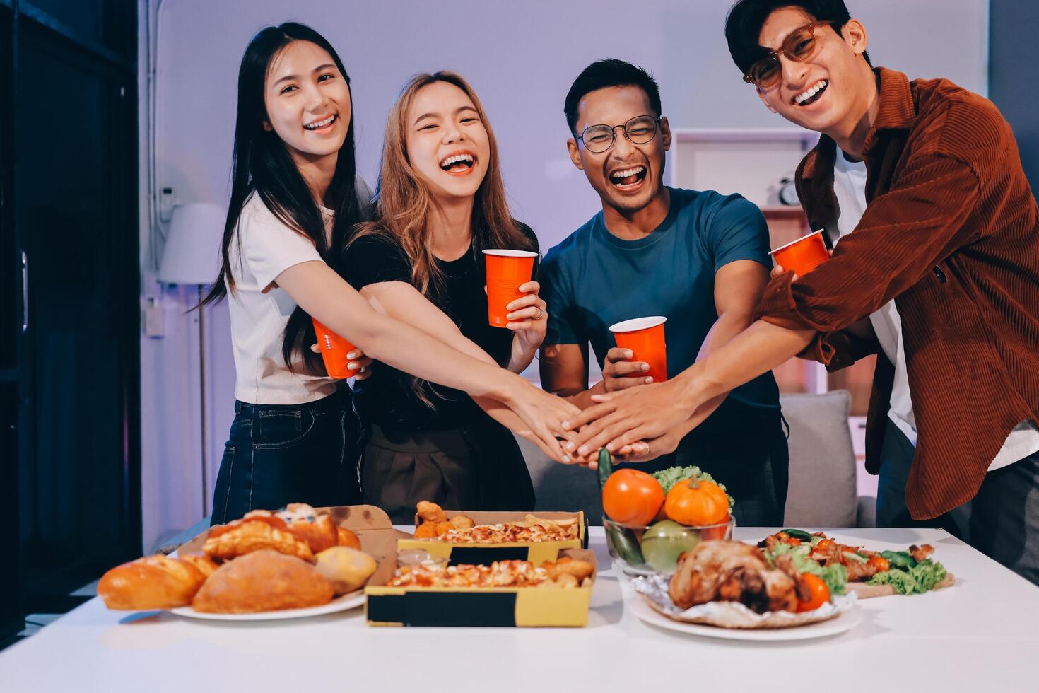 Happy asian friends having fun at dinner party photo