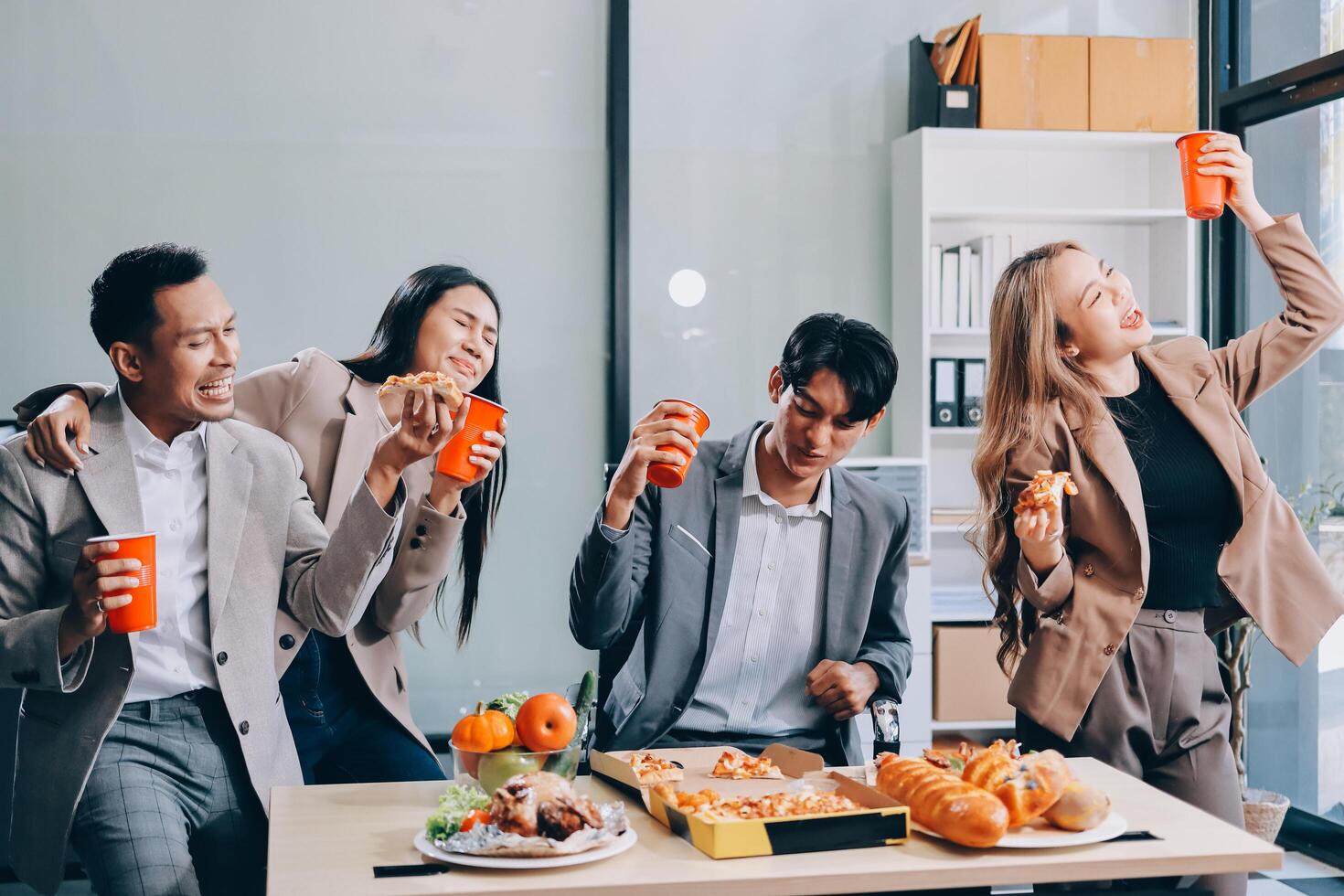 Group of business people enjoying food and drinks photo