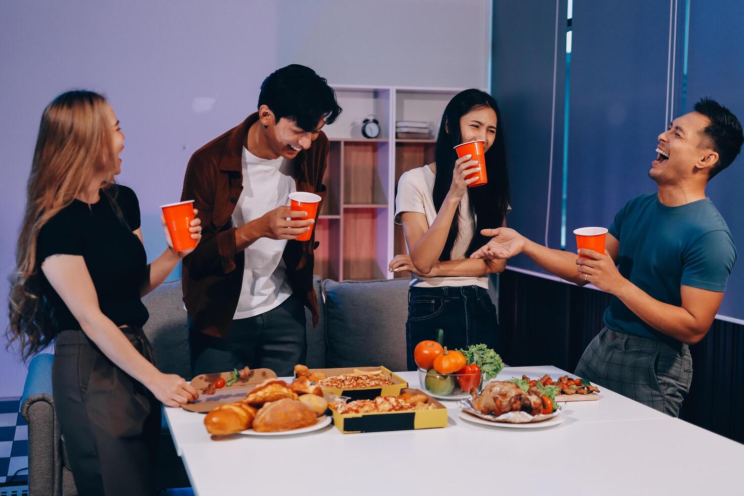Four friends having a meal together with drinks photo