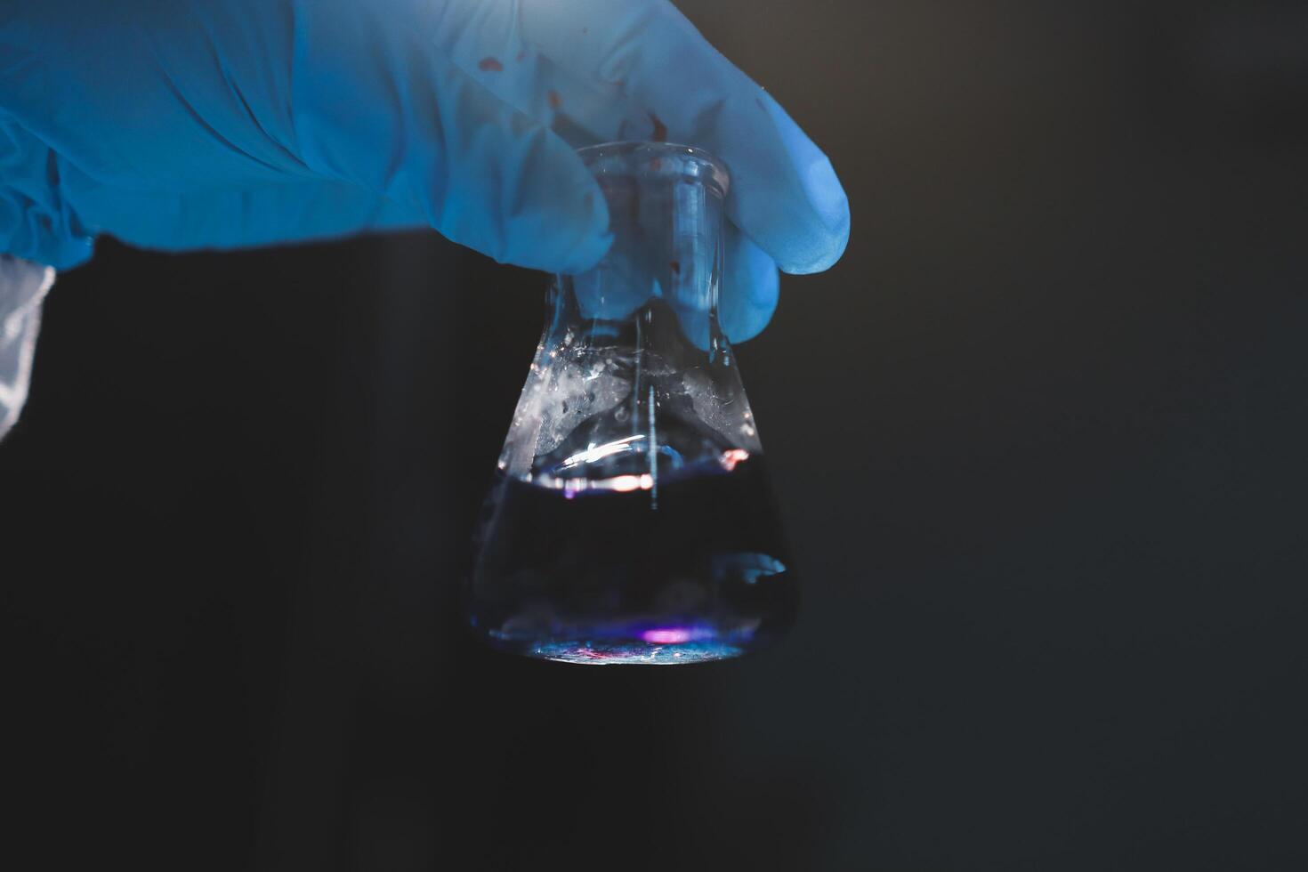 A person holding a flask with a liquid in it photo
