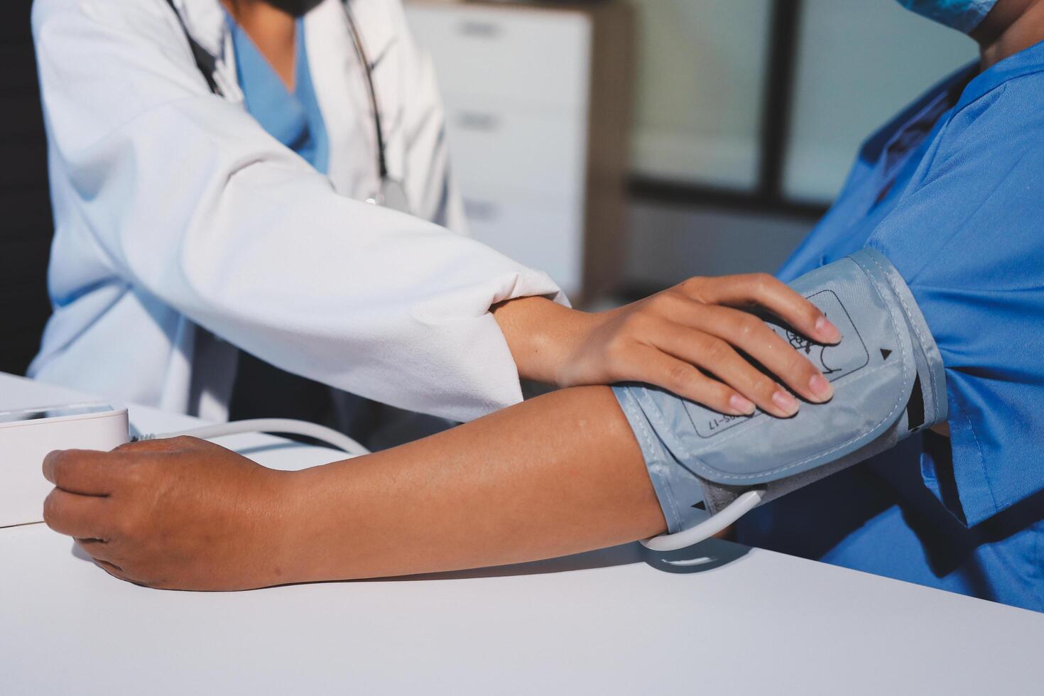 A doctor checking the blood pressure of a patient photo