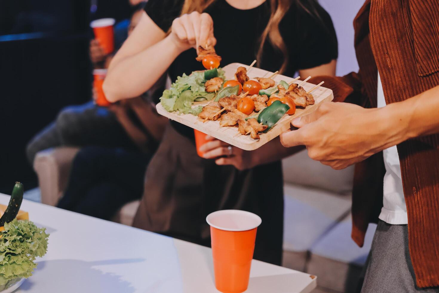 A man and woman are holding a tray of food photo