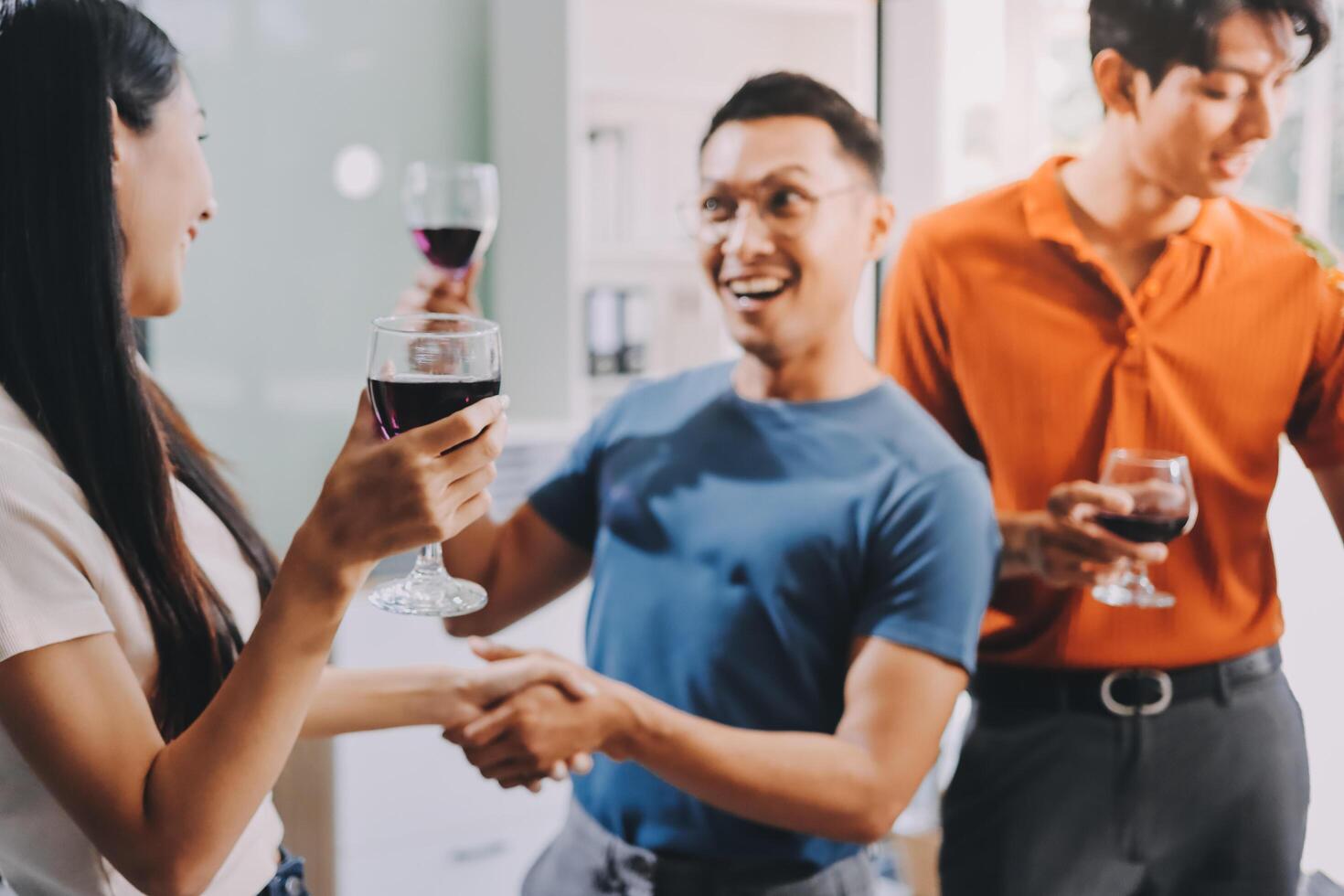 Three people holding wine glasses and smiling photo