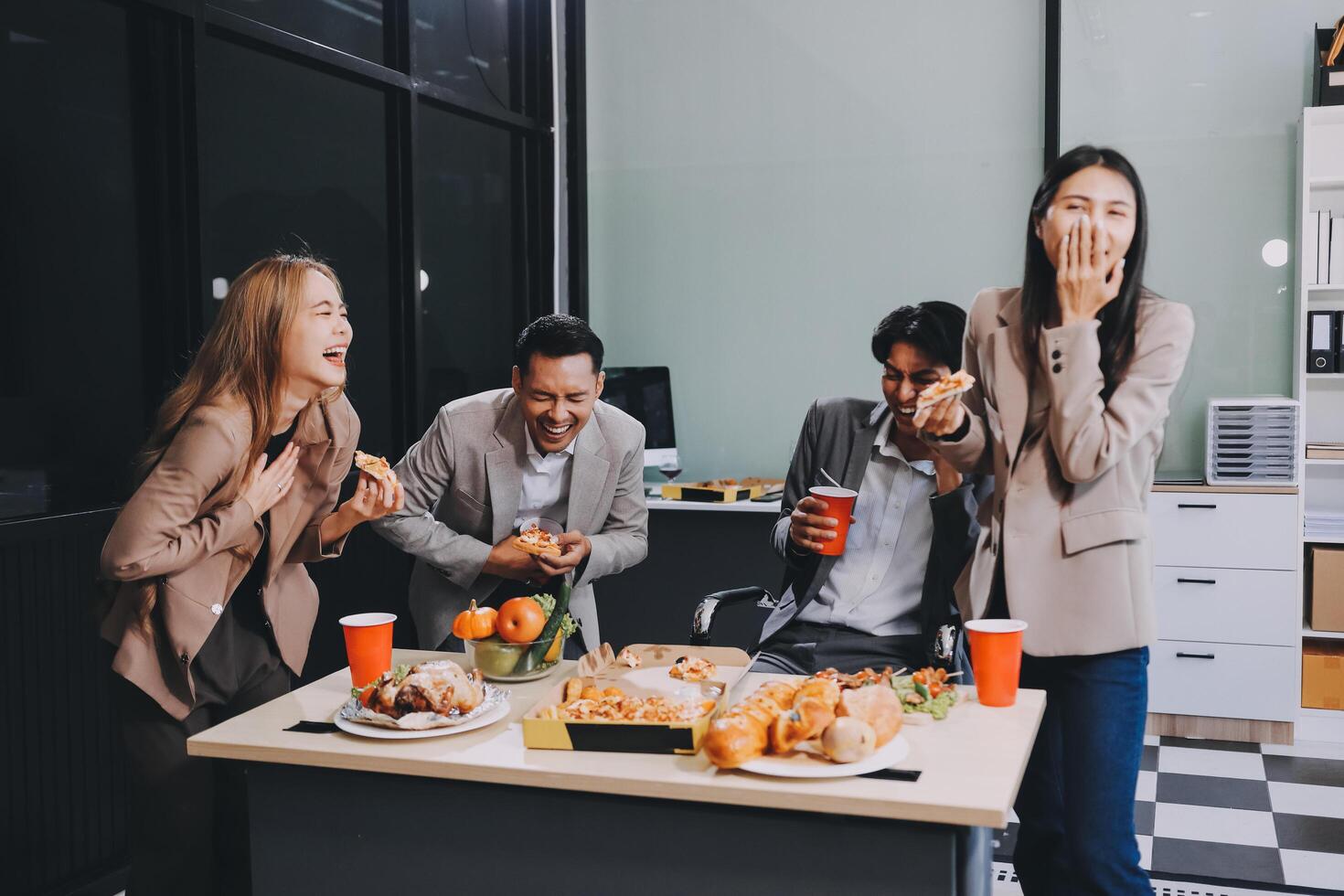 Group of business people eating food in office photo